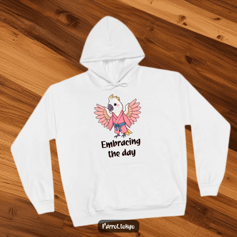 Funny cheerful parrot in a pink kimono, spreading its wings in a gentle arc, on a warm and humorous hoodie.